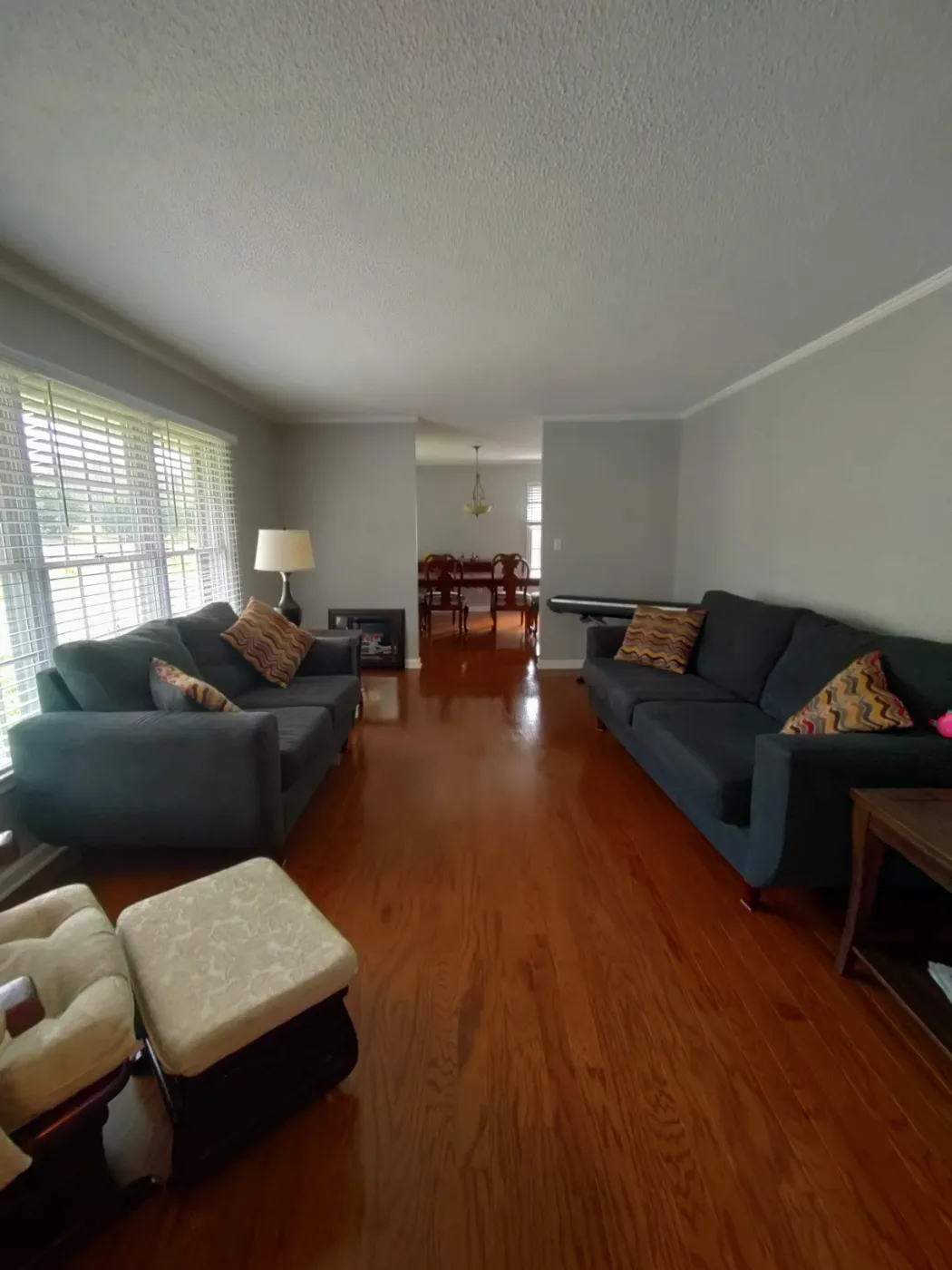 Clean living room with sofas and hardwood floors in a Cleveland, TN home
