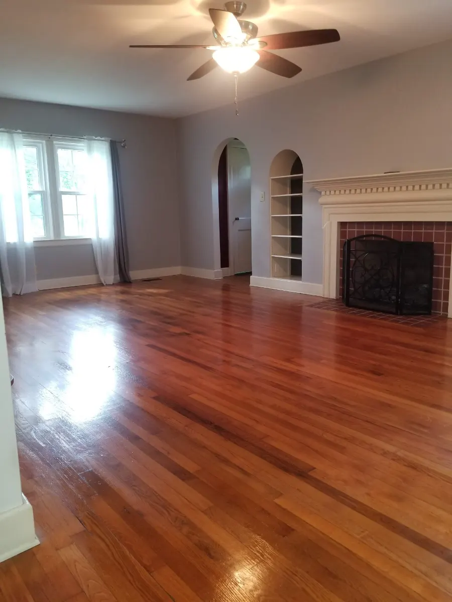 Empty living room with gleaming hardwood, cleaned by Dust Free By DD in Cleveland, TN