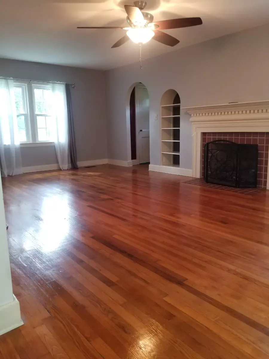 Empty living room with gleaming hardwood, cleaned by Dust Free By DD in Cleveland, TN
