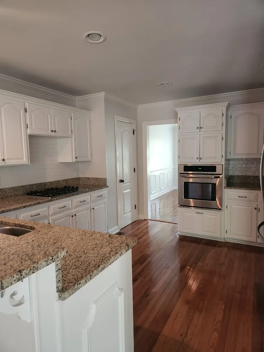 Granite counters and white cabinets wiped down, cleaned by Dust Free By DD in Cleveland, TN